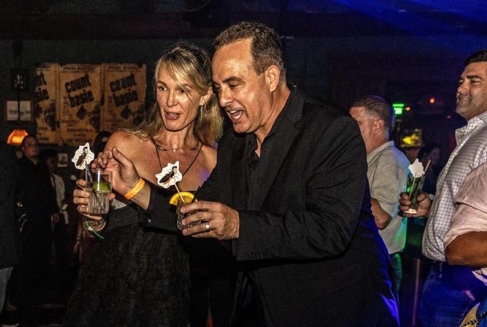 Little Havana businessman William &#x00201c;Bill&#x00201d; Fuller and his lawyer Courtney Caprio, toast with drinks that included drink shakers with a cockroach image with the face of City of Miami Commissioner Joe Carrollo as they celebrated winning a $63.5 million lawsuit over Miami City Commissioner Joe Carollo at Ball &amp; Chain,, on Saturday, June 03, 2023.