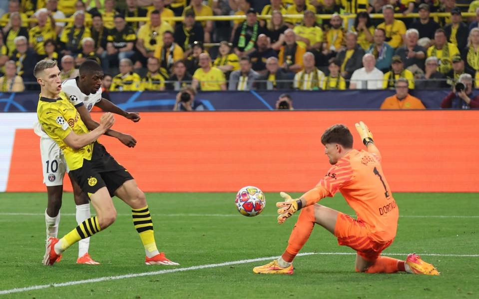 Gregor Kobel of Borussia Dortmund saves the shot of Ousmane Dembele of Paris Saint-Germain during the UEFA Champions League semi-final