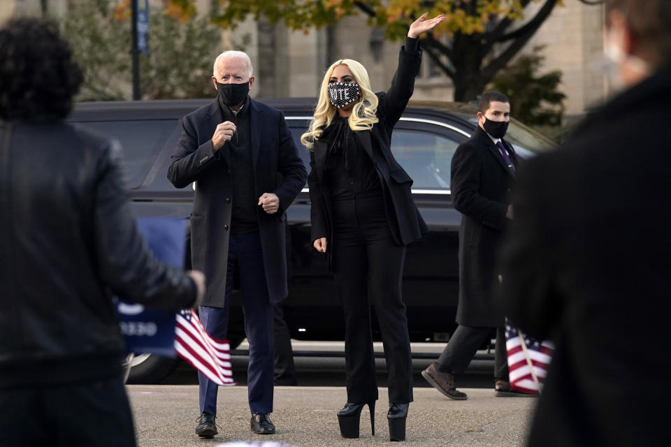 Democratic presidential candidate former Vice President Joe Biden stands with Lady Gaga at Schenley Plaza, Monday, Nov. 2, 2020, in Pittsburgh, Pa. (AP Photo/Andrew Harnik)