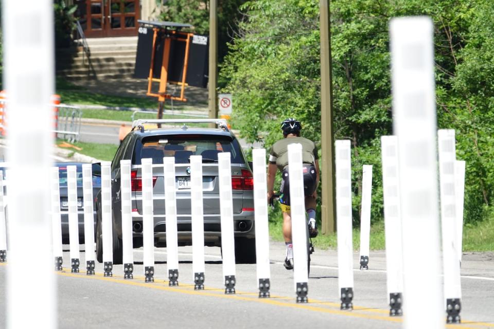 Bollards dot the centre line of Camillien-Houde Way to prevent motorists from making illegal U-turns — a manoeuvre that killed a cyclist in 2017. 