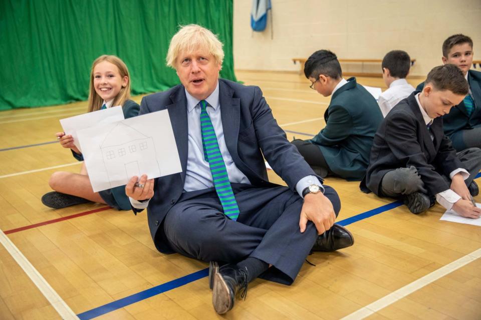 Boris Johnson mingled with pupils in Coalville on their first day back at school (Jack Hill/Pool/AP)