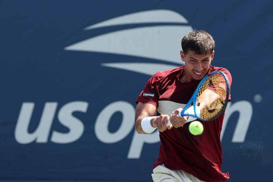 Alexei Popyrin hits a backhand.