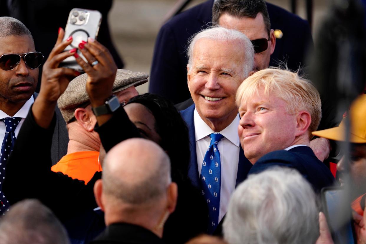 President Joe Biden takes a photo with Cincinnati City Councilman Mark Mark Jeffreys after touting a $1.6 billion federal investment in the long-awaited upgrade of the Brent Spence Bridge, Wednesday, Jan. 4, 2023, in Covington, Ky. The bridge spans the Ohio River connecting Ohio and Kentucky. Biden was joined by Ohio Gov. Mike DeWine, Kentucky Gov. Andy Beshear, Sen. Mitch McConnell and other state and local leaders.