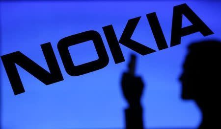 A photo illustration of a man silhouetted against a Nokia logo in the central Bosnian town of Zenica January 23, 2014. REUTERS/Dado Ruvic