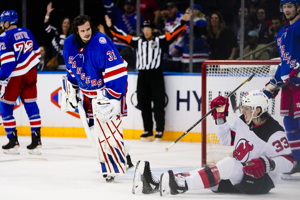 New York Rangers goaltender Igor Shesterkin (31) looks down at New Jersey Devils' Ryan Graves (33) after stopping a shot by Graves during the second period of an NHL hockey game Friday, March 4, 2022, in New York. (AP Photo/Frank Franklin II)