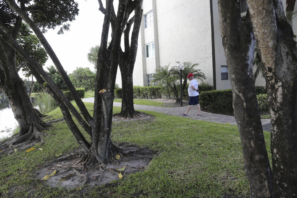 Mark Rousseau walks along the path where a couple claim a bobcat attacked them Friday, Oct. 4, 2019, in Fort Lauderdale, Fla. The woman was hospitalized with serious wounds and her husband was also treated for injuries. Florida wildlife officials say attacks by bobcats on humans are rare and wildlife experts say it usually happens when the animal is rabid or otherwise sick. (Amy Beth Bennett/South Florida Sun-Sentinel via AP)