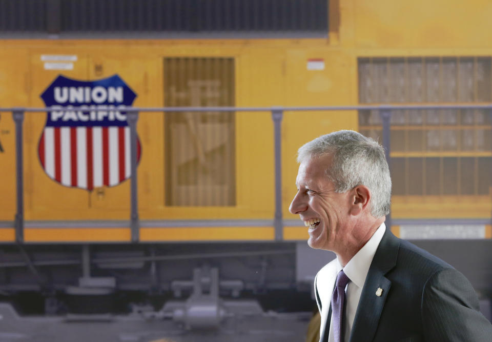 FILE- Union Pacific Chairman, President, and CEO Lance Fritz smiles after a news conference at the Durham Museum in Omaha, Neb., on Feb. 17, 2017. Union Pacific announced Wednesday, July 26, 2023, it has replaced Fritz with its former chief operating officer Jim Vena as the new CEO. The Soroban Capital Partners hedge fund that holds a $1.6 billion stake in Union Pacific had been urging the railroad to hire Vena because of his expertise in streamlining operations.(AP Photo/Nati Harnik, File)