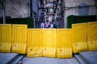 Lines of laundry are seen hanging between apartments behind barricades, which have been built to block buildings from a street, after the lockdown was lifted in Wuhan