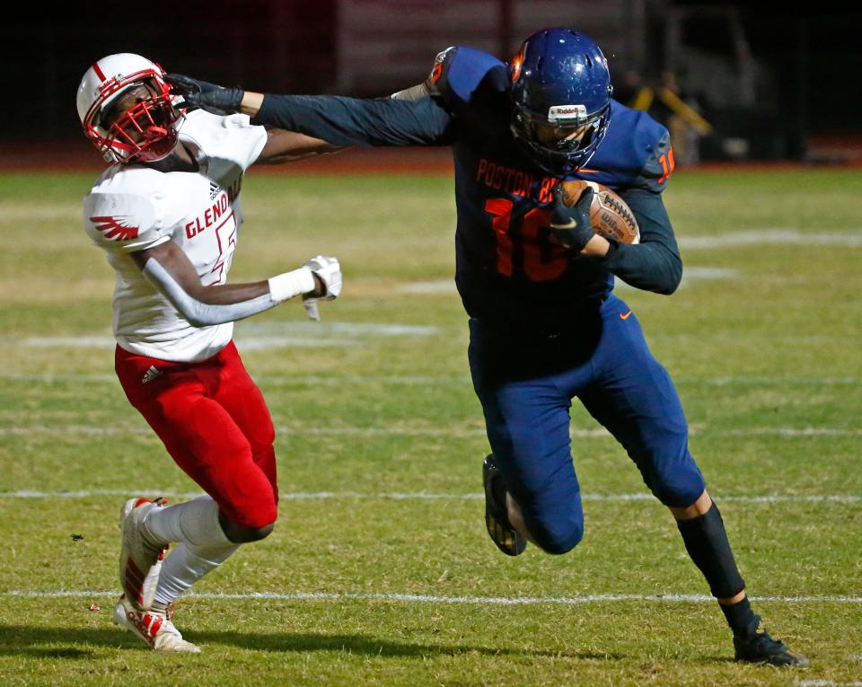 December 3, 2021; San Tan Valley, USA; Poston Butte's Connor Lopez (10) stiff arms Glendale's Junior Dukulay (5) during the 4A Semifinal game at Poston Butte High School. Patrick Breen-Arizona Republic