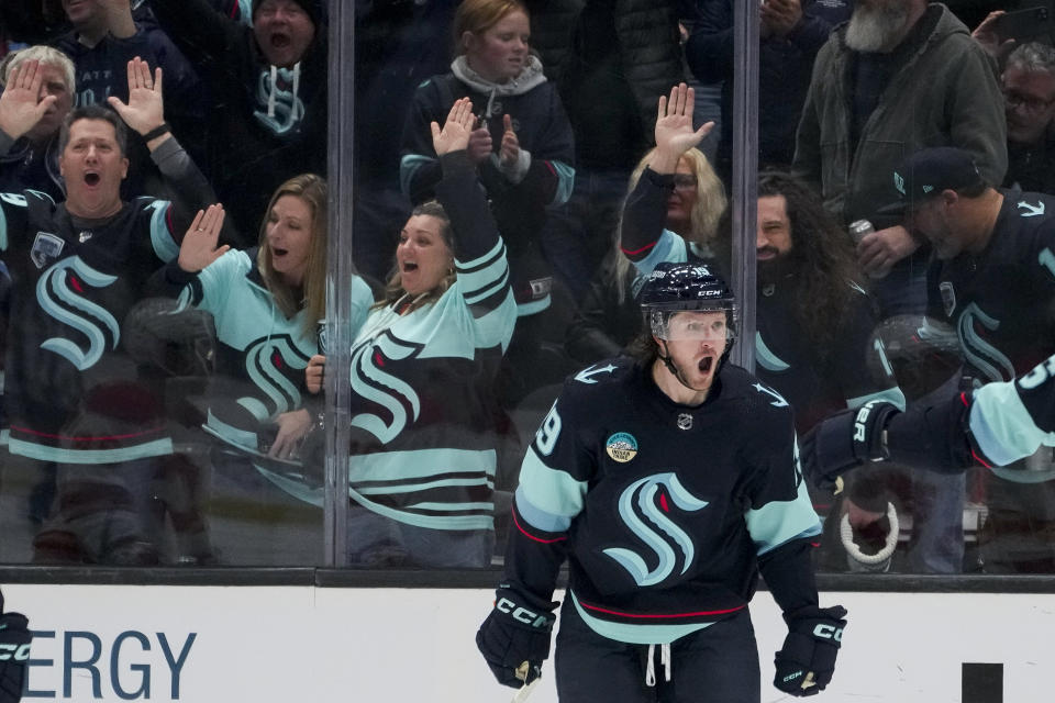 Seattle Kraken left wing Jared McCann, front, reacts after scoring against the Calgary Flames during the second period of an NHL hockey game Monday, Nov. 20, 2023, in Seattle. (AP Photo/Lindsey Wasson)