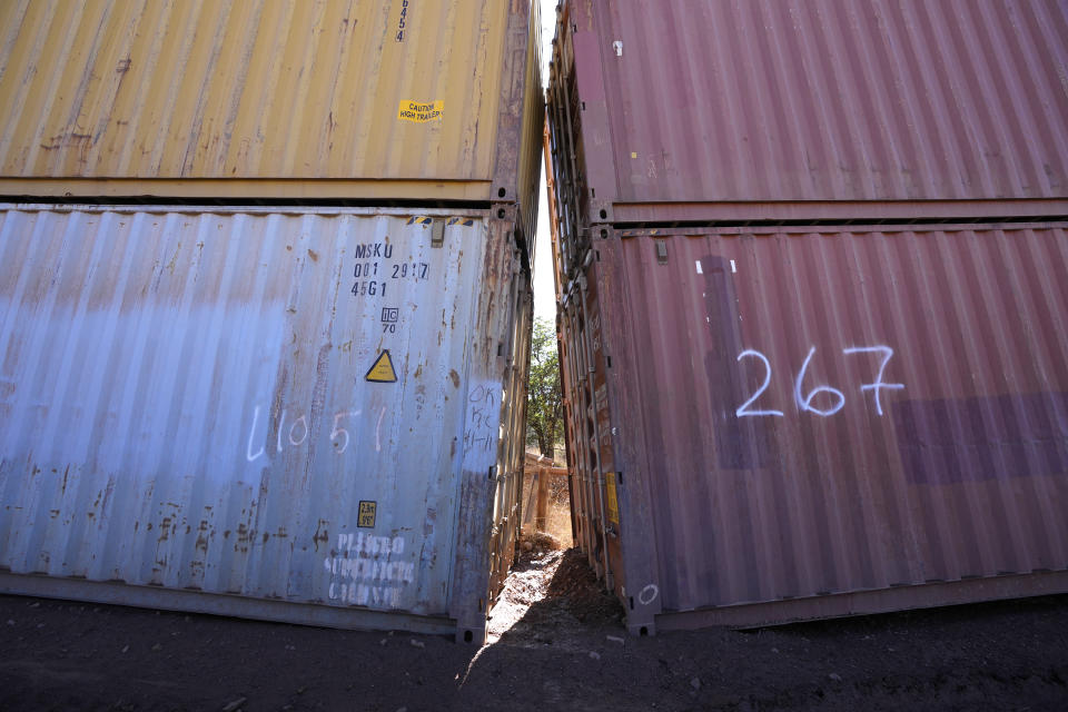 An awkward gap is shown between shipping containers at the bottom of a wash along the border where shipping containers create a wall between the United States and Mexico in San Rafael Valley, Ariz., Thursday, Dec. 8, 2022. Work crews are steadily erecting hundreds of double-stacked shipping containers along the rugged east end of Arizona’s boundary with Mexico as Republican Gov. Doug Ducey makes a bold show of border enforcement even as he prepares to step aside next month for Democratic Governor-elect Katie Hobbs. (AP Photo/Ross D. Franklin)