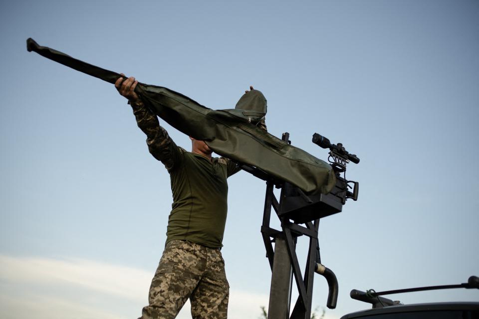 A soldier of a mobile anti-aircrafts brigade prepares a 12.7mm calibre heavy machine gun near a training field in the Khmelnytsky region (AFP via Getty Images)