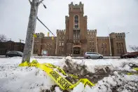 Police tape remains on the ground outside of the Main Street Armory on Monday, March 6, 2023, in Rochester, N.Y. (AP Photo/Lauren Petracca)