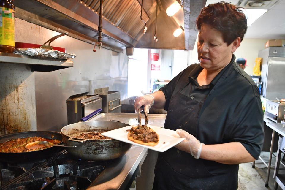 Maria Casillas, owner of Las Alteñitas Mexican Restaurant, prepares a huaraches plate Tuesday, April 19, 2022.