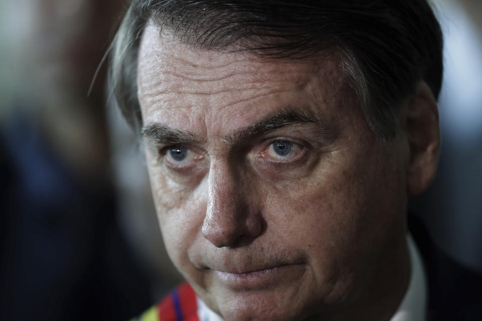 Brazil's President Jair Bolsonaro listens to a reporter's question at the end of a military ceremony where he was awarded the Order of Military Judicial Merit, in Brasilia, Brazil, Thursday, March 28, 2019. Bolsonaro, a former army captain who waxes nostalgic for the 1964-1985 dictatorship, on Monday asked Brazil’s Defense Ministry to organize “due commemorations” to mark the upcoming March 31st anniversary of Brazil’s 1964 military coup. (AP Photo/Eraldo Peres)
