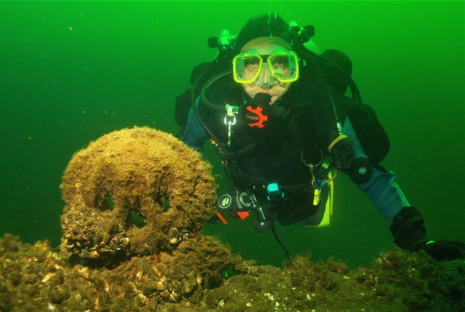 Durrell Martin, seen here posing with a deadeye on a gunwale of the wreck of the George Marsh in Lake Ontario, is the president of Save Ontario Shipwrecks, a non-profit group dedicated to preserving the maritime history of the Great Lakes. 