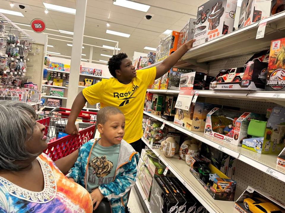 Sir-Anthone Yarn, 13, reaches for a Sky Viper drone while shopping with his grandmother Tawanda Simmons and younger sibling King Yarn. Sir-Anthone enjoyed sharing the moment with his classmates from Lincoln Middle School.