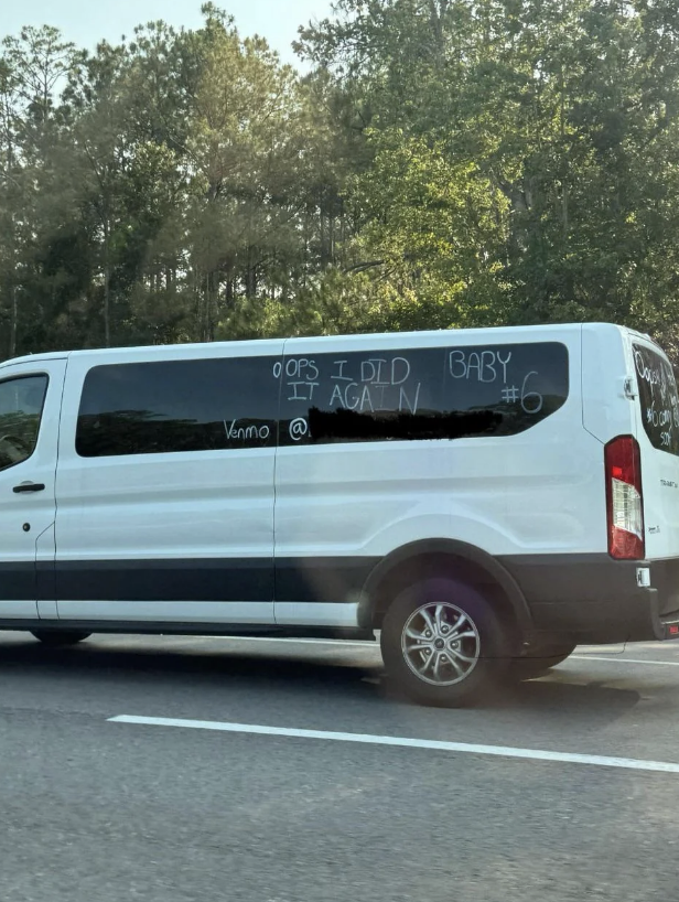 A large white van with "Oops, I did it again. Baby #6" written on the side. It also has "Venmo @" written on a window, indicating a request for donations