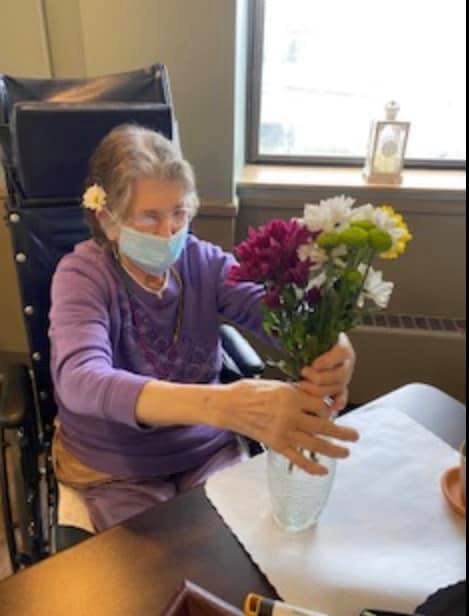 Mary Ann Eberst, 79, arranges flowers during the first day of visitation at Rochester Manor and Villa in Beaver County. After 100% of residents were vaccinated, administrators began allowing limited face-to-face visitation.