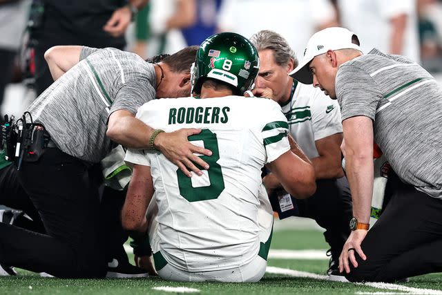 <p>Michael Owens/Getty</p> Aaron Rodgers #8 of the New York Jets is looked at by the medical staff on the field for an apparent injury during a game against the Buffalo Bills at MetLife Stadium on September 11, 2023 in East Rutherford, New Jersey