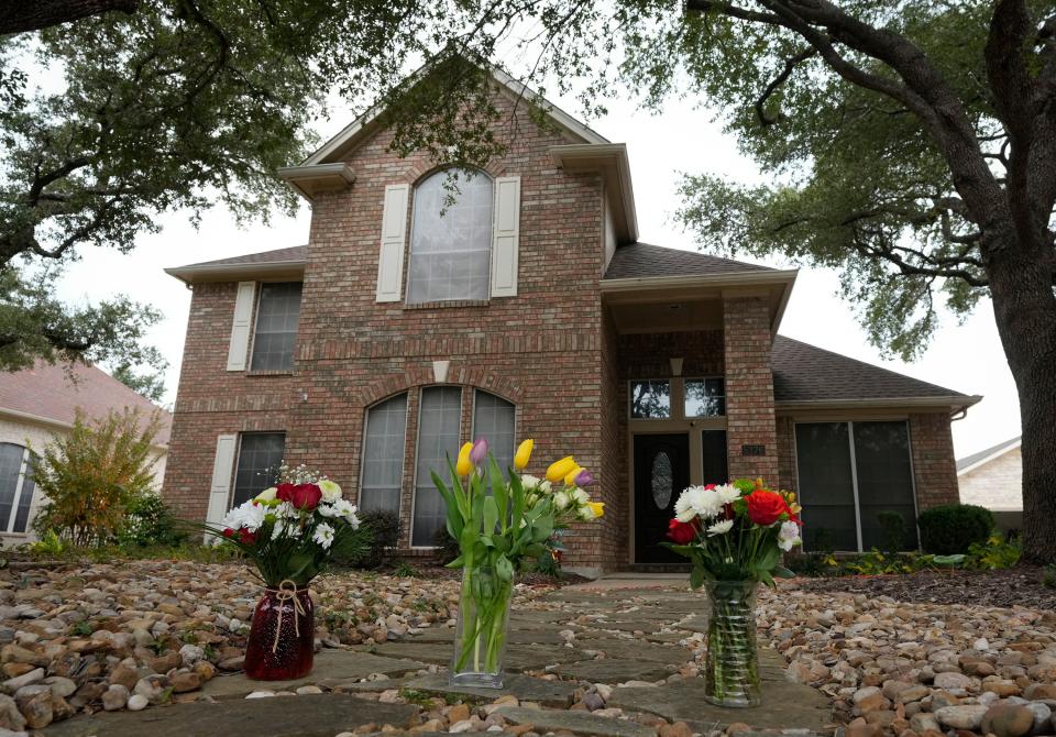 Flowers are left outside the house on Austral Loop in the Circle C Ranch neighborhood where Katherine Short, 56, and daughter Lauren Short, 30, were killed Tuesday.