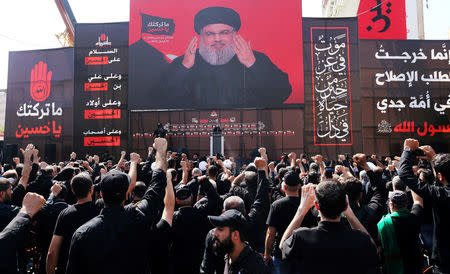 Lebanon's Hezbollah leader Sayyed Hassan Nasrallah gestures as he addresses his supporters via a screen during last day of Ashura, in Beirut, Lebanon September 20, 2018. REUTERS/Aziz Taher