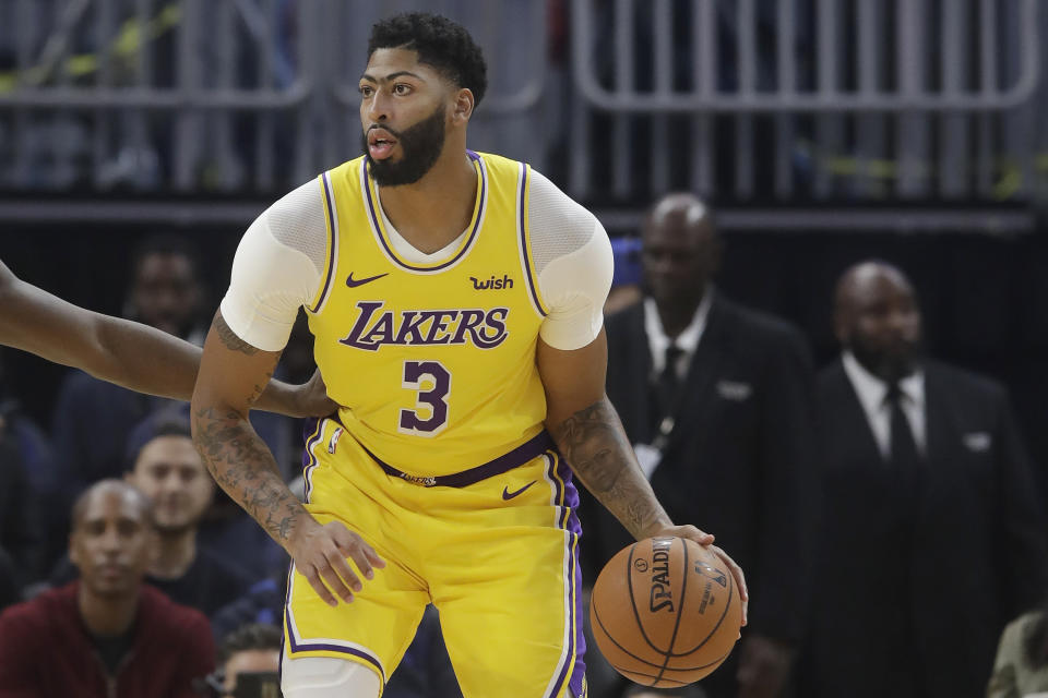 Los Angeles Lakers forward Anthony Davis dribbles during the first half of the team's preseason NBA basketball game against the Golden State Warriors in San Francisco, Saturday, Oct. 5, 2019. (AP Photo/Jeff Chiu)