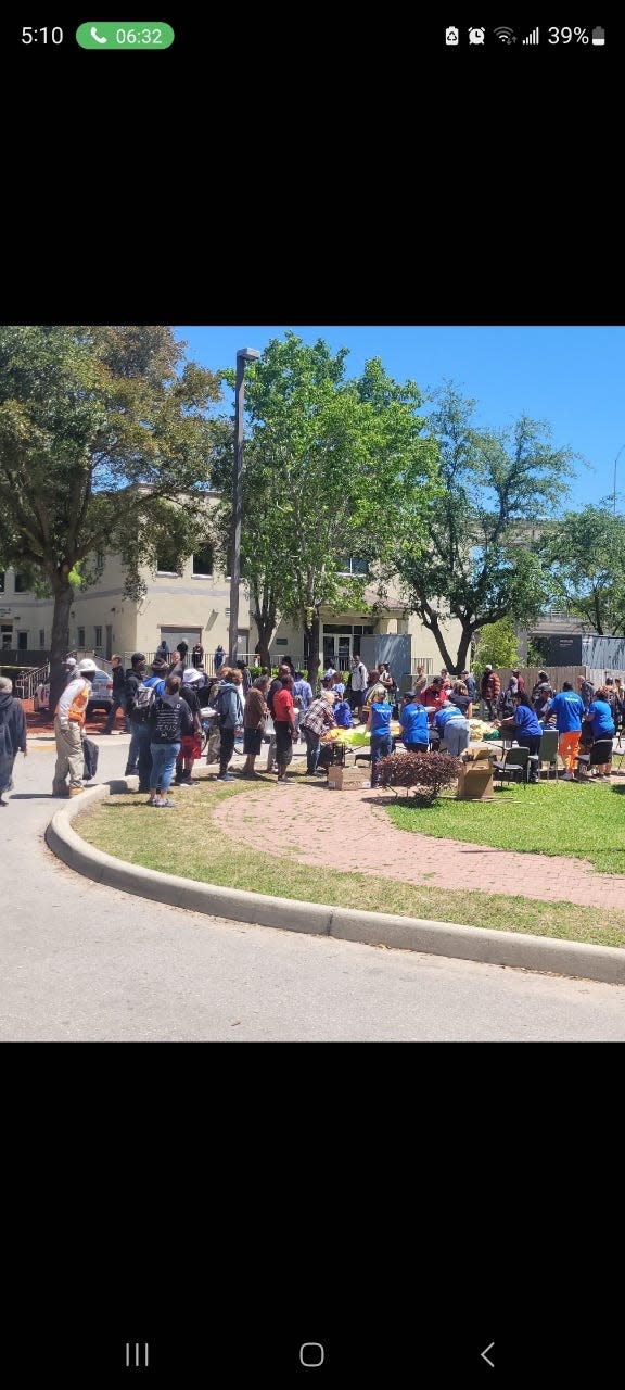 Volunteers from Sam's Club and two nonprofits, the Donovin Darius Foundation and B.O.L.D. Endeavors, distribute clothing to clients at the Sulzbacher homelessness nonprofit's downtown Jacksonville center.