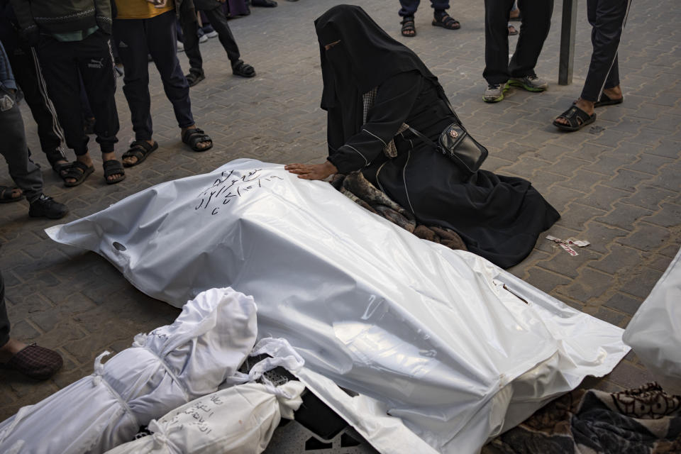 Palestinians mourn their relatives killed in the Israeli bombardment of the Gaza Strip, at the hospital Rafah, southern Gaza, Tuesday, Dec. 19, 2023. (AP Photo/Fatima Shbair)