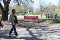 A sign in Fort Greene Park in Brooklyn, New York City, reminds people to social distance during the coronavirus pandemic on Wednesday, April 22, 2020. (AP Photo/Ted Shaffrey)