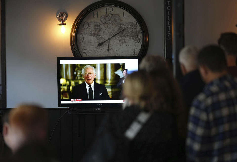 Members of the public watching a broadcast of King Charles III first address to the nation as the new King following the death of Queen Elizabeth II, in The Prince Harry Pub, Windsor, England, Friday, Sept. 9, 2022. (John Walton/PA via AP)