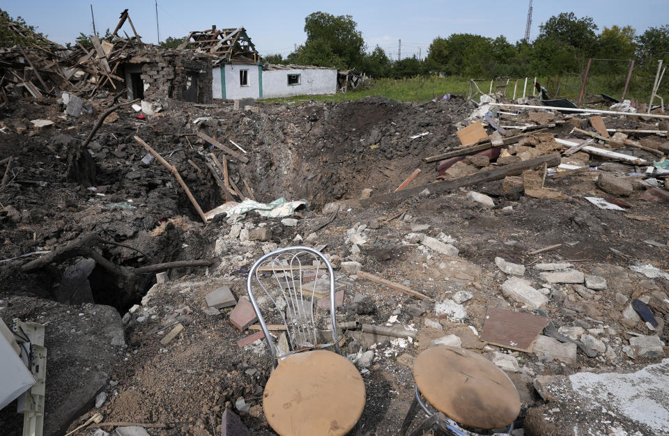 Destroyed houses after a Russian attack are seen in the village Chaplyne, Ukraine, Thursday, Aug. 25, 2022. The death toll from a Russian rocket attack on a train station and the surrounding area as Ukraine celebrated its Independence Day climbed to 25, including at least two children, Ukrainian authorities said Thursday. Russia said it targeted a military train and claimed to have killed more than 200 Ukrainian reservists. (AP Photo/Inna Varenytsia)