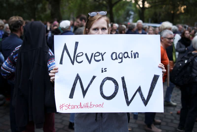 People attend a vigil in front of the Fraenkelufer synagogue in Berlin