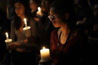 <p>Natalynn Rivis, a student at University of Nevada Las Vegas, right, takes part in a vigil Monday, Oct. 2, 2017, in Las Vegas. A gunman on the 32nd floor of the Mandalay Bay casino hotel rained automatic weapons fire down on the crowd of over 22,000 at an outdoor country music festival Sunday. (Photo: Gregory Bull/AP) </p>