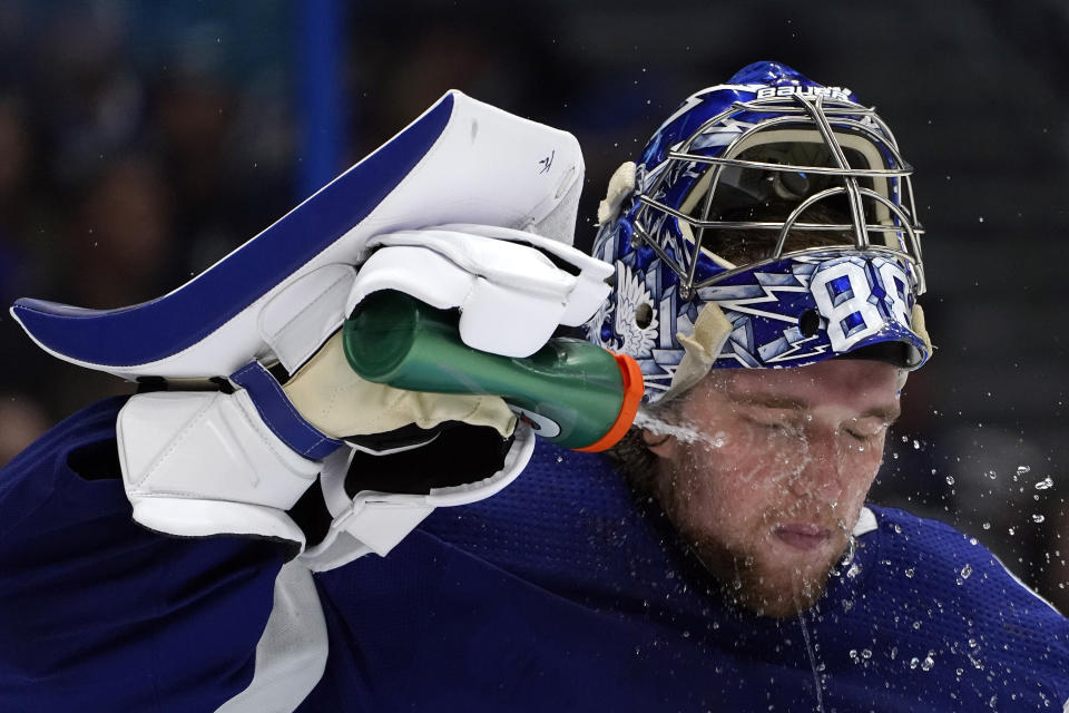 Tampa Bay Lightning goaltender Andrei Vasilevskiy (88) sprays water on his face during the third period in Game 1 of an NHL hockey Stanley Cup semifinal playoff series against the New York Islanders Sunday, June 13, 2021, in Tampa, Fla. (AP Photo/Chris O'Meara)