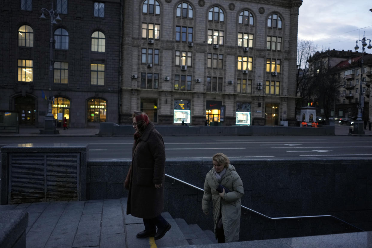 Women exit a metro, in central Kyiv, Ukraine, Tuesday, Feb. 21, 2023. (AP Photo/Thibault Camus)