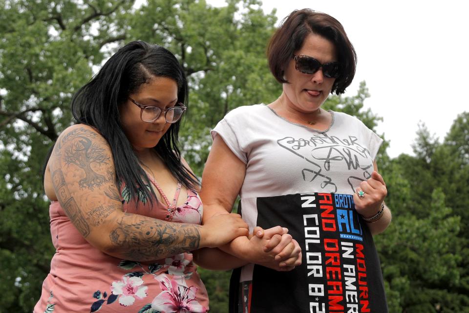 Ashley Quinones, left, widow of Brian Quinones, who was killed by Edina and Richfield police in 2019, and Courteney Ross, the girlfriend of George Floyd, hold each other during an event to release balloons in honor of their deceased loved ones at Powderhorn Park in Minneapolis on Saturday, June 6, 2020.