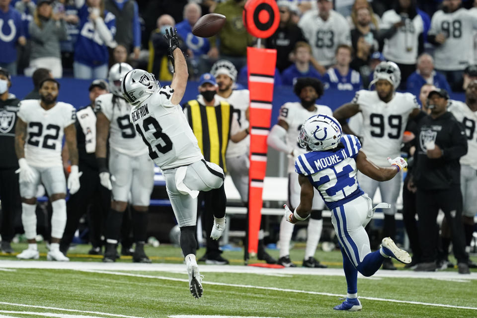 Las Vegas Raiders wide receiver Hunter Renfrow (13) catches a pass ahead of Indianapolis Colts cornerback Kenny Moore II (23) during the second half of an NFL football game, Sunday, Jan. 2, 2022, in Indianapolis. (AP Photo/Darron Cummings)