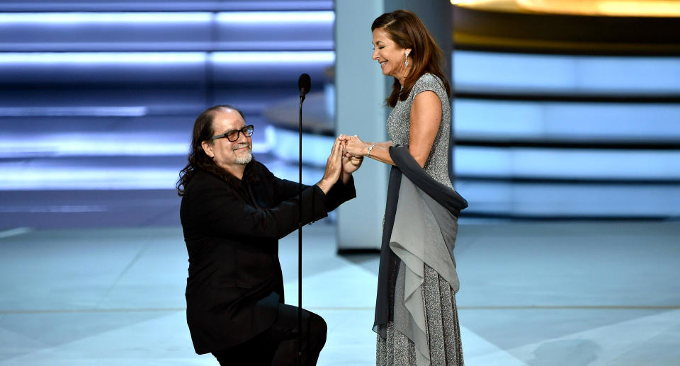 Glenn Weiss (L), winner of the Outstanding Directing for a Variety Special award for The Oscars, proposes marriage to Jan Svendsen onstage during the 70th Emmy Awards at the Microsoft Theatre in Los Angeles, California on September 17, 2018. (Photo by Robyn BECK / AFP)