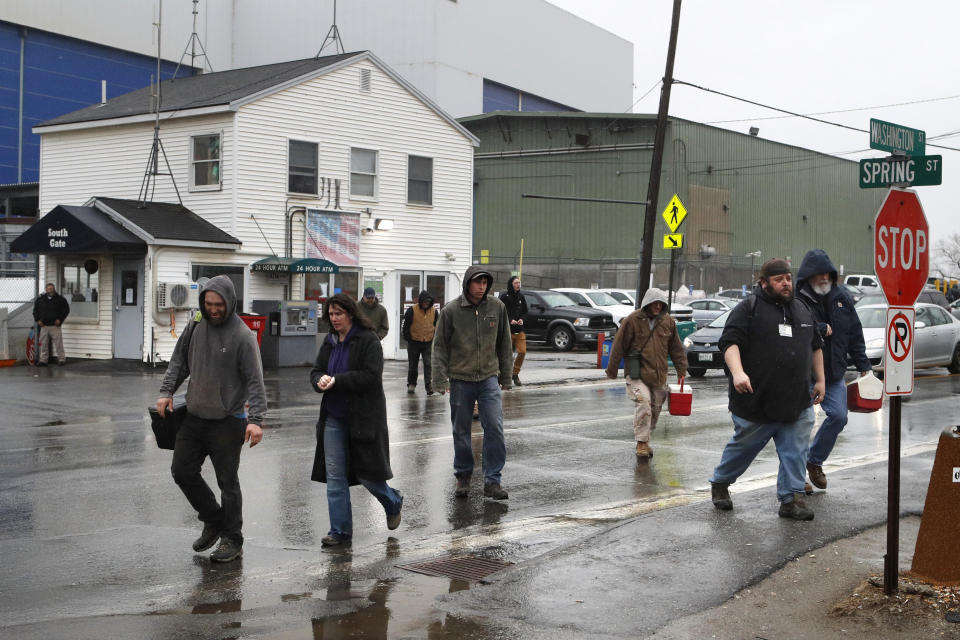 Workers leave Bath Iron Works after a shift, Friday, April 3, 2020, in Bath, Maine. At least two workers at the defense contractor have been diagnosed with the coronavirus. (AP Photo/Robert F. Bukaty)