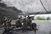 Cadets learn to fire a 105mm howitzer, Friday, Aug. 7, 2020, at the U.S. Military Academy in West Point, N.Y. The pandemic is not stopping summer training. Cadets had to wear masks this year for much of the training. (AP Photo/Mark Lennihan)