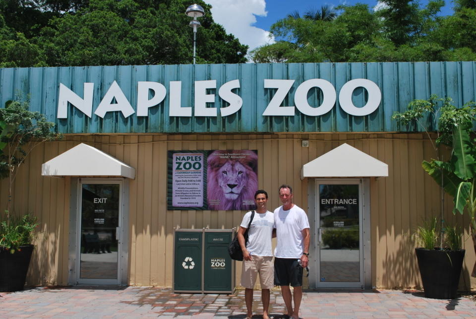 In this July 10, 2015, photo provided by Brad Balukjian, Brad Balukjian, left, stands with former major league pitcher Don Carmen outside Naples Zoo in Naples, Fla. Balukjian tore open a pack of 1986 Topps baseball cards, chewed the stale, brittle bubblegum and then planned a journey to meet every player whose image appeared on those old pieces of cardboard. (Brad Balukjian via AP)