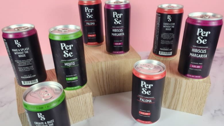 Cans of Per Se on wood blocks