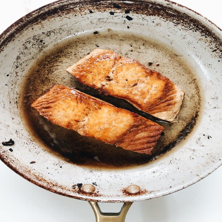 Two pieces of salmon in a skillet