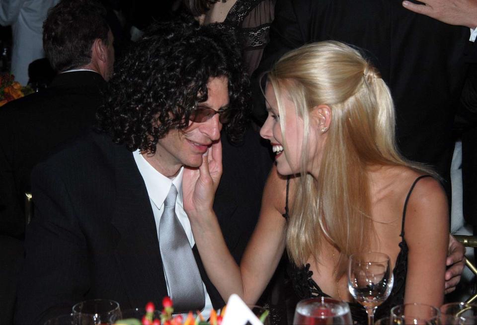 Howard Stern gets a loving caress from girlfriend Beth Ostrosky during a pre-Grammy party hosted by Clive Davis in the Grand Ballroom of the Regent Wall St. Hotel. The bash celebrated the return of the Grammy Awards to New York City for the first time since 1998