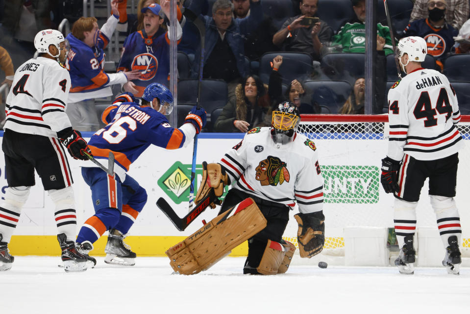 Chicago Blackhawks goaltender Marc-Andre Fleury (29) reacts as New York Islanders right wing Oliver Wahlstrom (26) celebrates a goal by Islanders defenseman Noah Dobson (8) for a tie during the third period of an NHL hockey game, Sunday, Dec. 5, 2021, in Elmont, N.Y. (AP Photo/Corey Sipkin).
