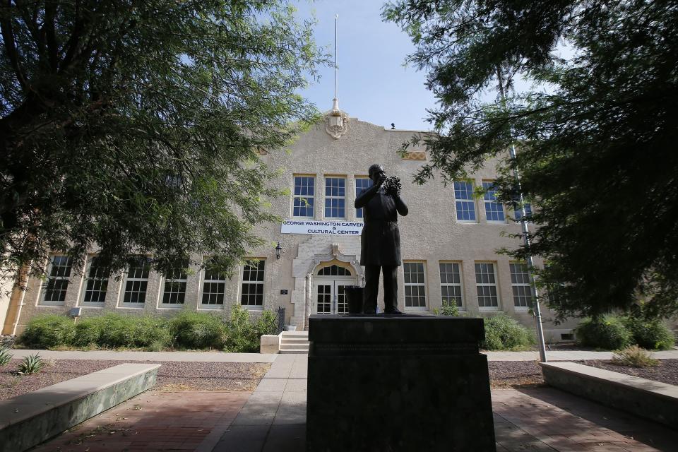 In this Thursday, July 25, 2019 photo, a statue of George Washington Carver stands outside the George Washington Carver Museum and Cultural Center in Phoenix. The museum was once the Carver High School, a segregated high school for African American school children in the Phoenix Union High School District from 1926 until 1954, when it was closed. Phoenix’s past segregation has been in focus after last month’s national outrage over a videotaped encounter of police pointing guns and cursing at a black family.(AP Photo/Ross D. Franklin)