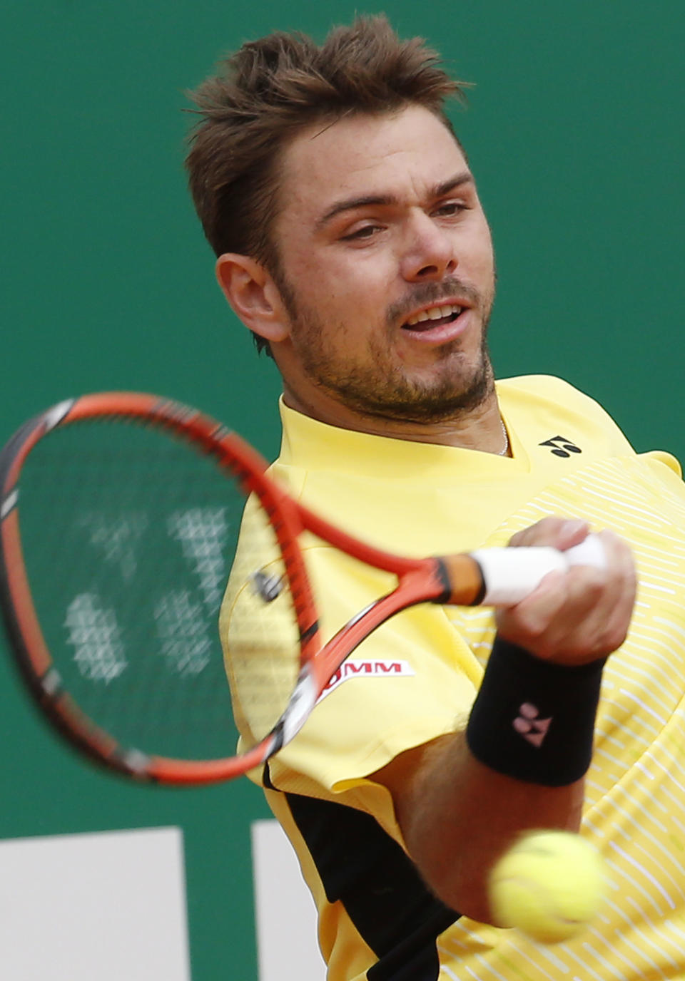 Stanislas Wawrinka of Switzerland returns to the ball to Milos Raonic of Canada during their quarterfinals match of the Monte Carlo Tennis Masters tournament in Monaco, Friday, April 18, 2014. Wawrinka won 7-6 6-2. (AP Photo/Michel Euler)