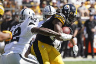 Pittsburgh Steelers running back Najee Harris (22) is tackled by Las Vegas Raiders inside linebacker Cory Littleton (42) and defensive back Johnathan Abram, rear, during the first half of an NFL football game in Pittsburgh, Sunday, Sept. 19, 2021. (AP Photo/Keith Srakocic)