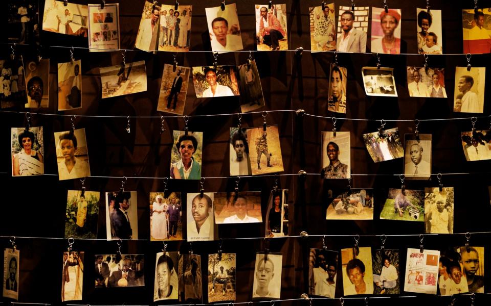 Family photographs of some of those who died hang on display in an exhibition at the Kigali Genocide Memorial centre in Rwanda - AP